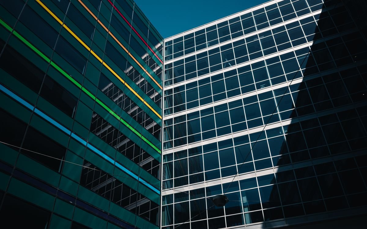 Modern glass office building with colorful reflective panels